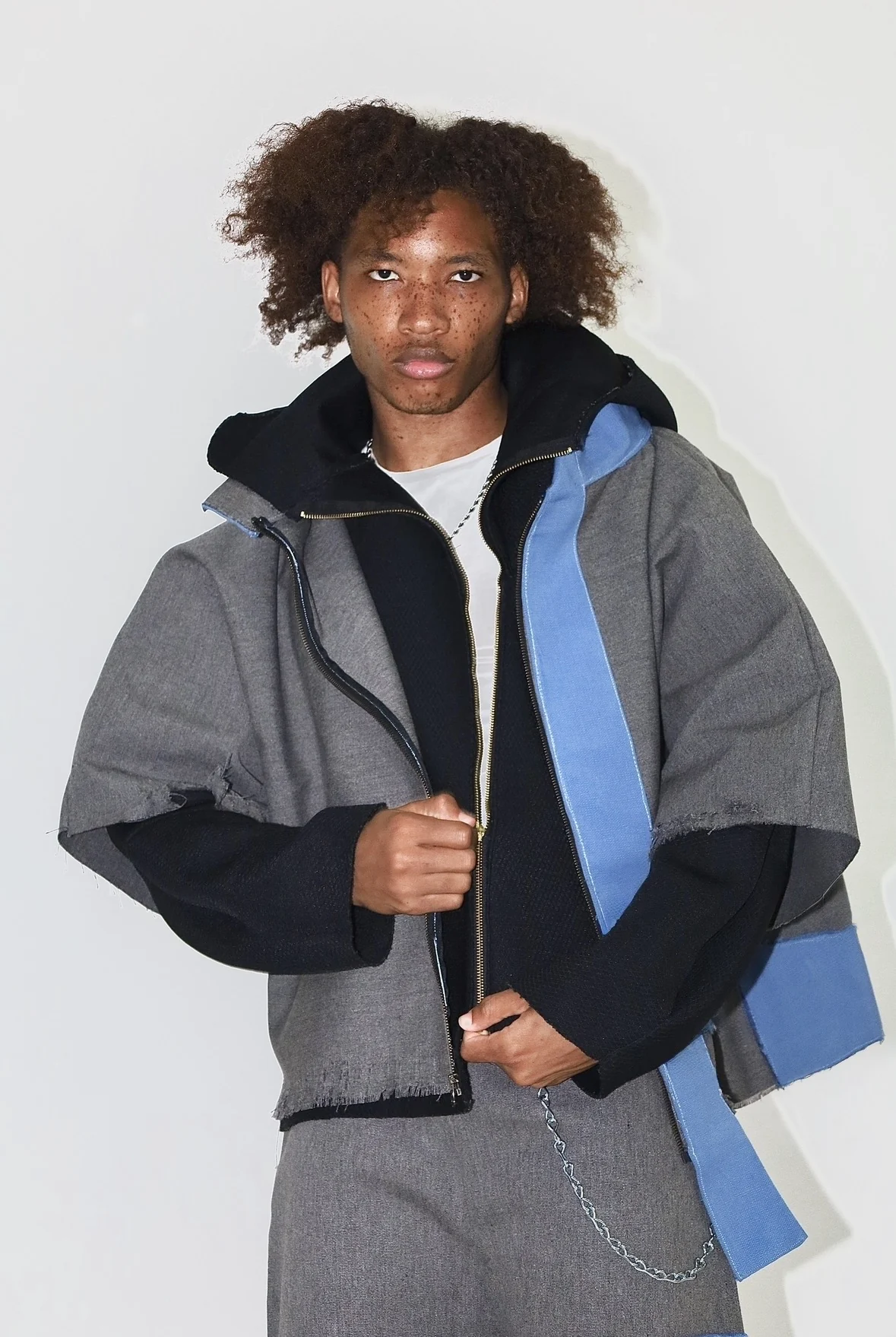 Model wearing MTSO grey and blue sculptural outerwear